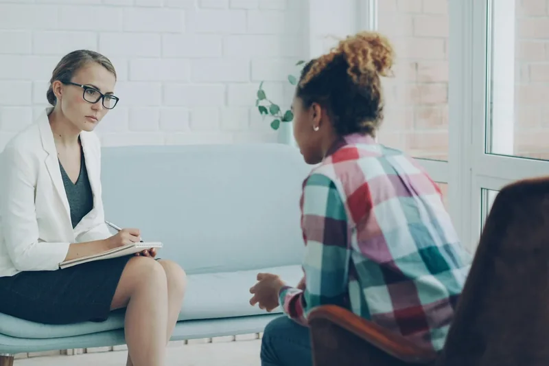 Adult speaking with a psychologist during an autism assessment