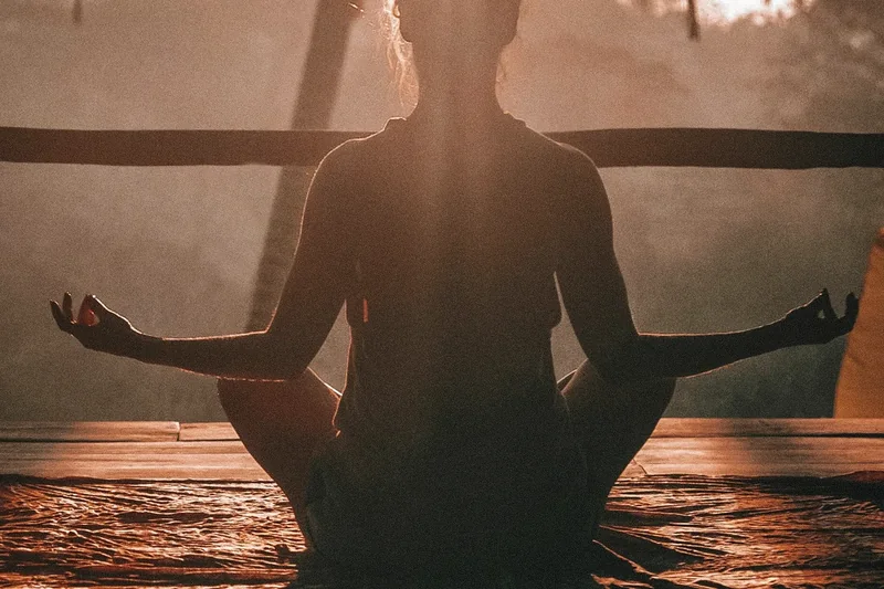 Person practising mindfulness in a calm setting